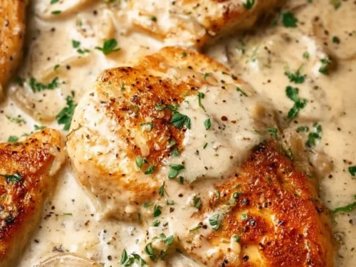 Baked sour cream and onion chicken garnished with herbs