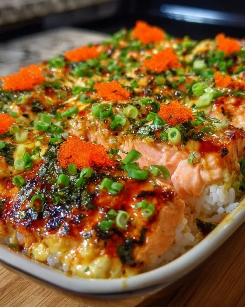 Easy spicy salmon sushi bake recipe with layered salmon, rice, and spicy sauce